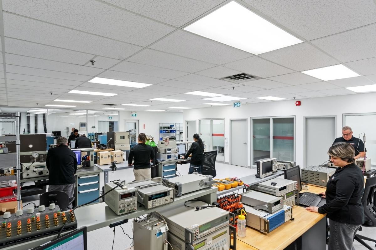 Full calibration lab with team of technicians at workstations